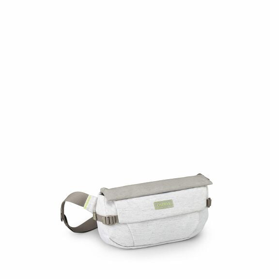 The image depicts a compact, stylish fanny pack made from a light gray fabric. It features a flap closure with a buckle, and the strap appears to be adjustable for convenience. A small rectangular patch with the brand name "Osprey" is sewn onto the flap, 
