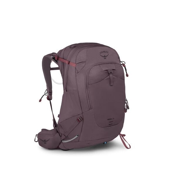 The image features an Osprey Mira 34 backpack designed for hiking or outdoor activities. It is predominantly plum-colored with several compartments and adjustable straps for securing the contents and ensuring comfort when worn. The backpack is equipped wi
