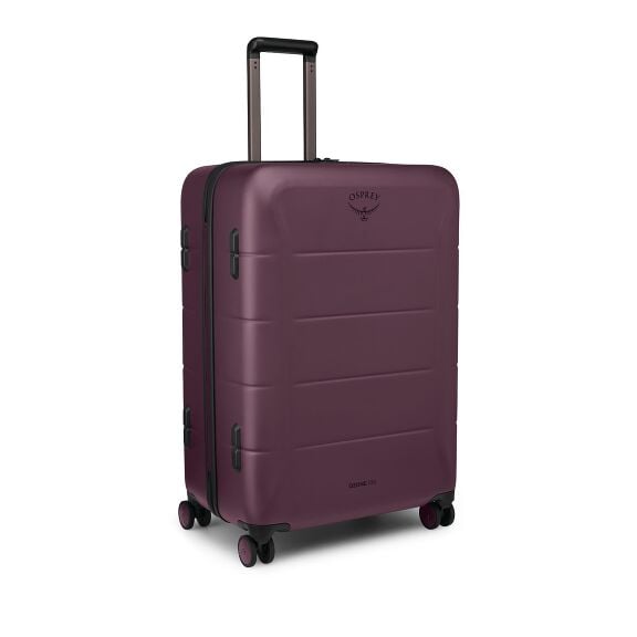 The images show a hard-shell rolling suitcase in a deep purple color with a telescoping handle and four spinner wheels. The case has a smooth, slightly rounded exterior with horizontal ridges and black trim and handles. The Osprey logo appears on the fron