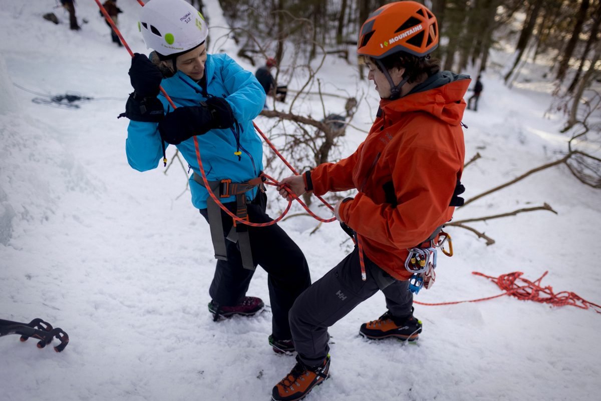 Woman gearing up to ice clim