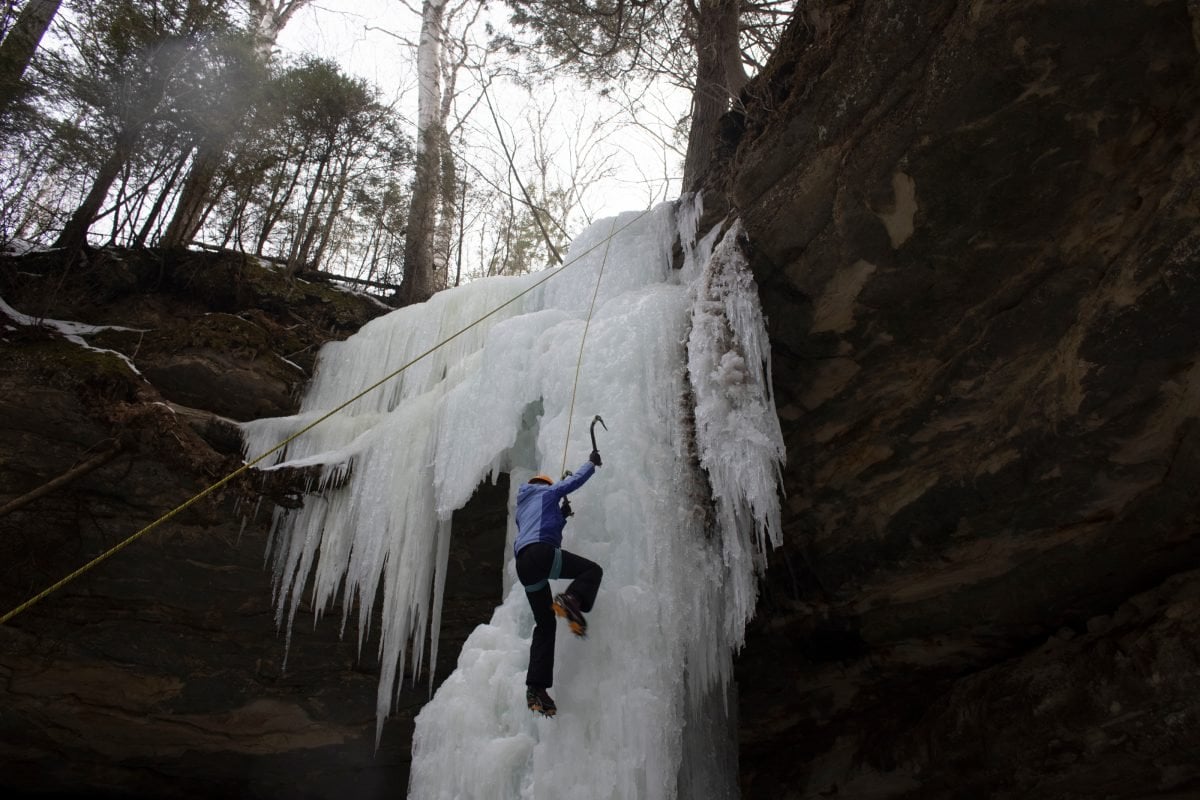 Woman ice climbing in Michigan