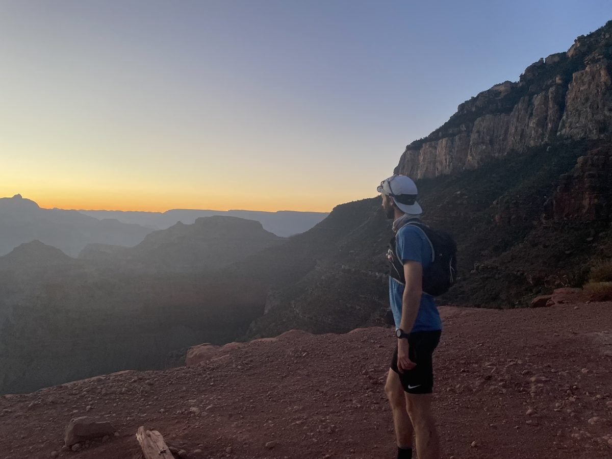 A man standing at an overlook along the Grand Canyon rim to rim trail