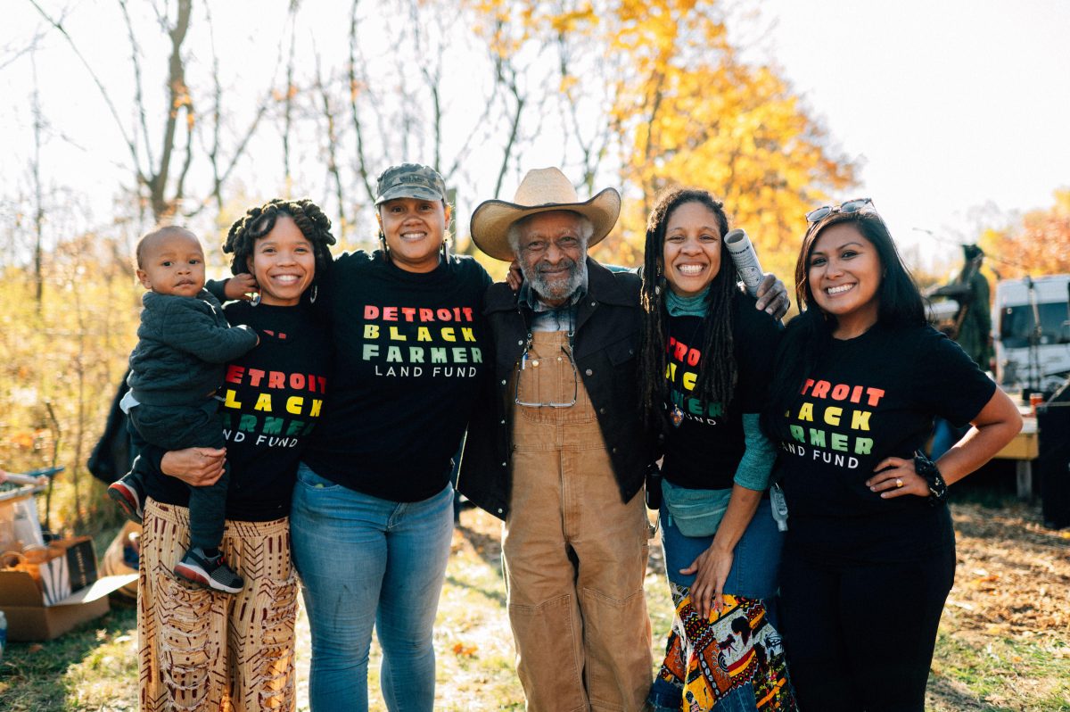 A group of people standing together wearing matching shirts that read 