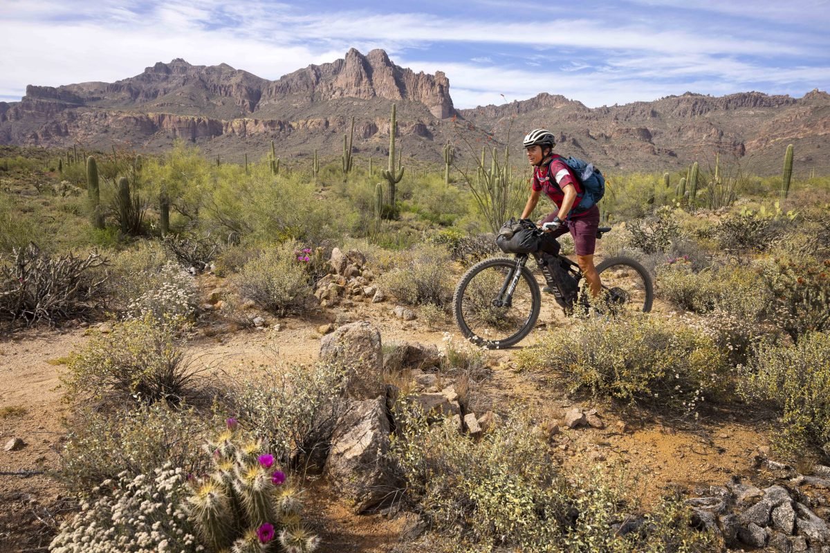 A person on a bike in a desert landscape