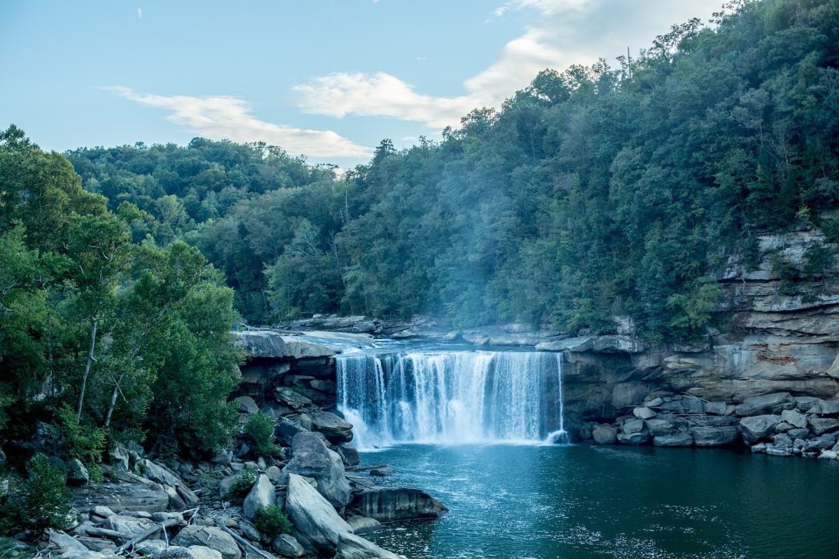 A waterfall surrounded by trees and rocky cliffs