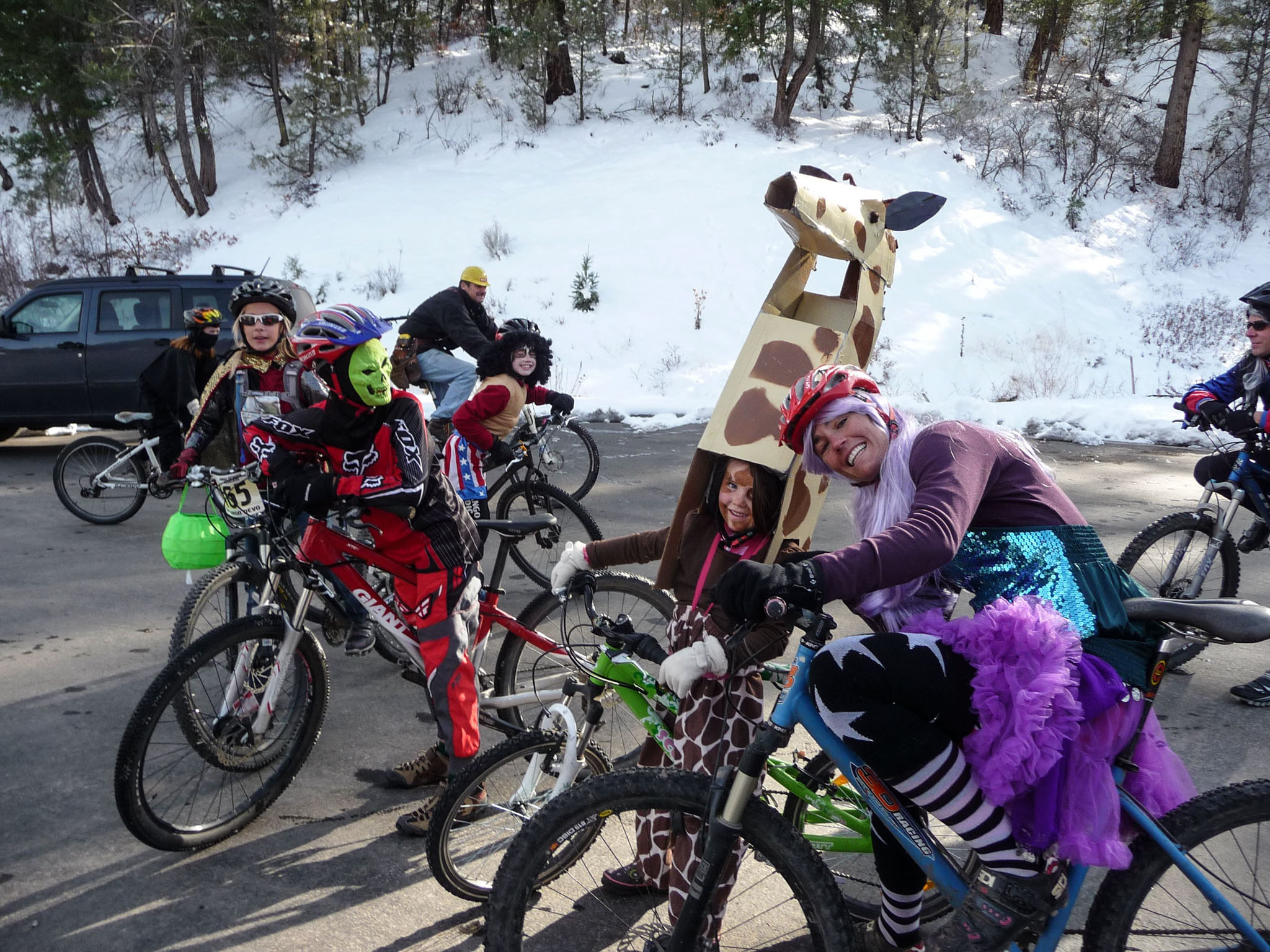 A group of cyclists in Halloween costumes.