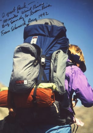 Color photo of Mike Pfotenhauer, Diane Wren, and twelve members of the Osprey team in front of a stone building.